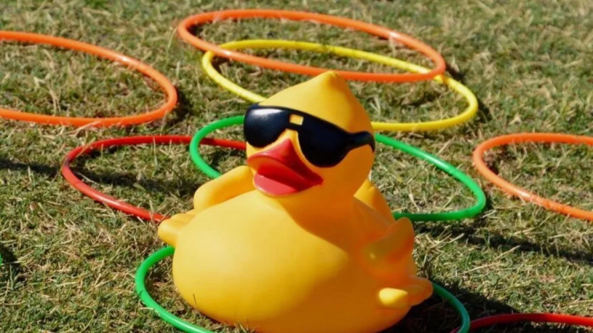 A corporate-branded rubber duck among yellow race ducks.