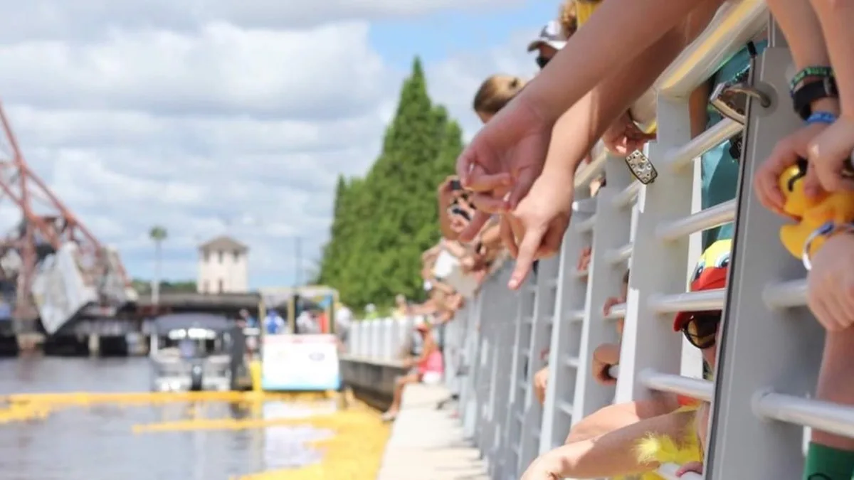 Derby duck race fans cheering in the crowd.