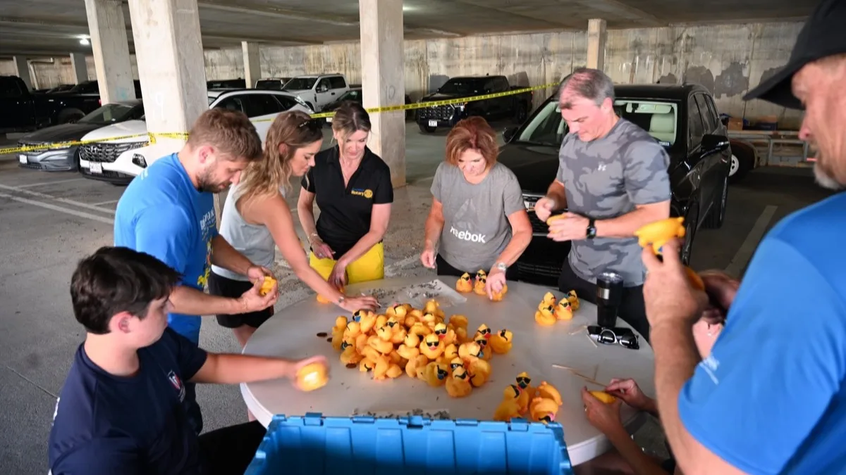 Volunteers tagging rubber ducks before a race.
